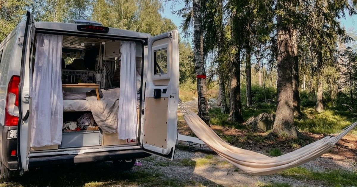 Campervan with open doors and a swinging hammock