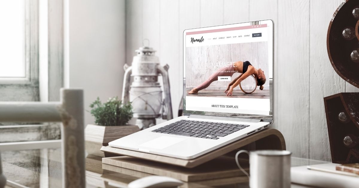 A yoga website homepage on a laptop propped on a desk
